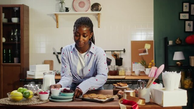 African american chef cooking biscuits. Confectioner woman portrait, preparing ingredients for cookies, milk and berries, tasty dessert. Baking sweet food and homemade treats. Bakery at home.