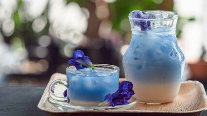 Butterfly pea flower water in a pitcher and glass, The bluish-purple color is very drinkable.