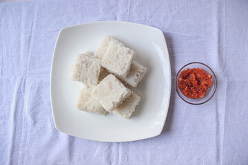 Top shot of a kiribath and a lunu miris plate on the white background for new year season. aurudu traditional food 