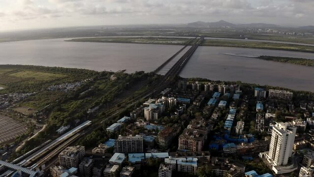 Vasai Creek Railway Bridge At Dusk From Bhayandar Suburb In Mumbai, India. - aerial