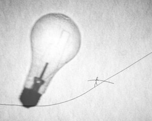 Risky idea concept mixed art drawing and photography. Walking the tight rope and shadow of lightbulb