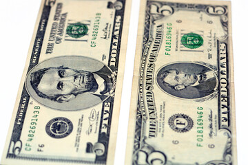Selective focus of 5 five dollars bill banknote features image of president Abraham Lincoln on...