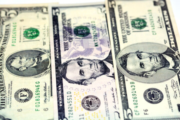 Selective focus of 5 five dollars bill banknote features image of president Abraham Lincoln on...