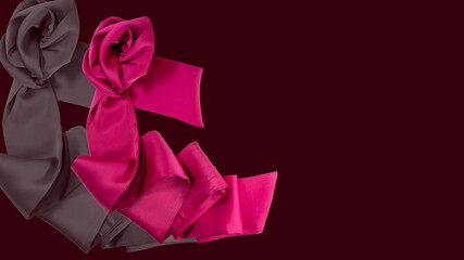 pink rose on a satin cloth with the smooth dark red background
