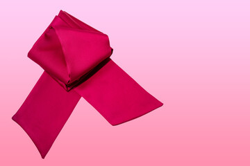 Red ribbon on smooth pink background