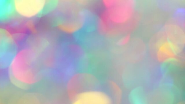 Pastel neon colors defocused lights bokeh. Sparkling highlights and rainbow colors. Abstract holographic background