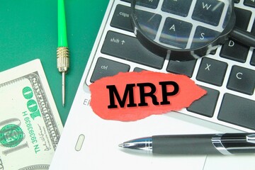laptop keyboard, arrows, colored paper with MRP letters or material requirements planning