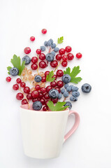 Composition - a berry fountain from a white cup.