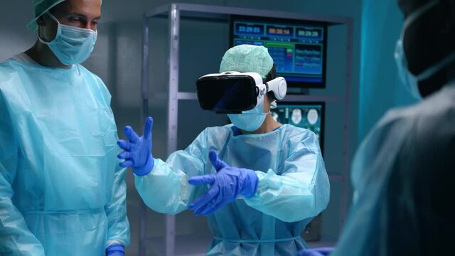 Team of professional medical surgeons performs the surgical operation in a modern hospital. Doctors are working to save the patient. Medicine, health, cardiology and transplantation concept.