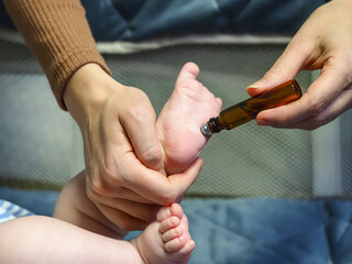 mom lubricates baby with essential oil
