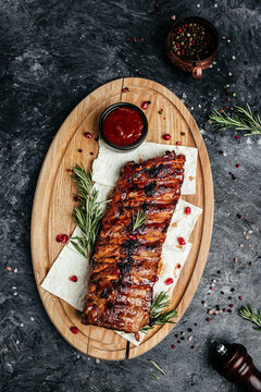 Grilled pork ribs with BBQ sauce. vertical image. top view. place for text
