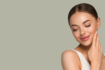 Beauty healthy skin women touching face cosmetic studio portrait. Sportswear color background green