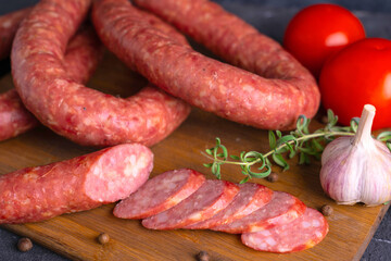 Sliced slices of homemade sausage. Homemade Krakow sausage on a cutting board