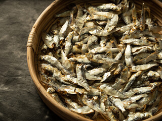 Fototapeta na wymiar dried anchovies on a wooden plate
