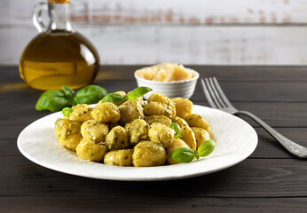 Gnocchi with pesto sauce and parmesan. Traditional Italian meal from potatoes.