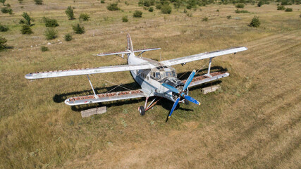 Old abandoned airplane on the field. Top view