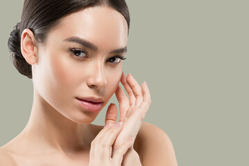 Asia woman beauty face body portrait touching her face healthy skin. Color background. Green