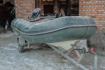 gray inflatable boat on a trailer. SUV car with trailer boat.