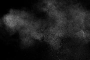 White powder explosion on black background. Abstract white dust texture.