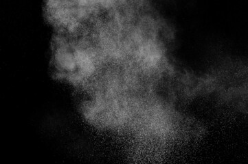 White powder explosion on black background. Abstract white dust texture.