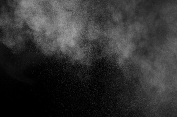 White powder explosion on black background. Abstract white dust texture.