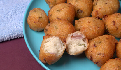 Delicious Indian snacks Punugulu served in a plate with Tomato and green Chutney
