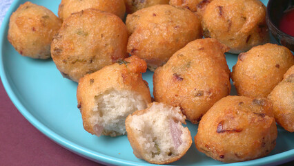 Delicious Indian snacks Punugulu served in a plate with Tomato and green Chutney
