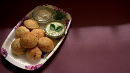 Appum or Appe, Appam or Mixed dal or Rava Appe served with green   chutney. A Ball shape popular south Indian breakfast dish, Selective focus
