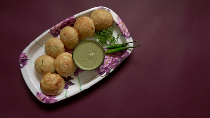 Appum or Appe, Appam or Mixed dal or Rava Appe served with green   chutney. A Ball shape popular south Indian breakfast dish, Selective focus
