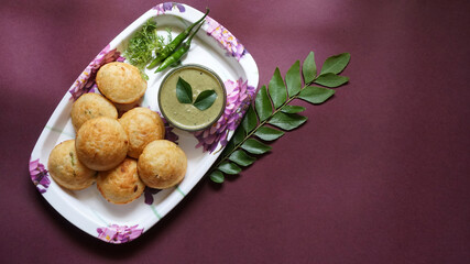 Appum or Appe, Appam or Mixed dal or Rava Appe served with green   chutney. A Ball shape popular south Indian breakfast dish, Selective focus
