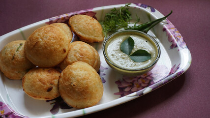 Appum or Appe, Appam or Mixed dal or Rava Appe served with green   chutney. A Ball shape popular south Indian breakfast dish, Selective focus
