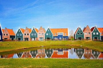 Panorama with modern brick houses along water in a family friendly suburban neighborhood in...