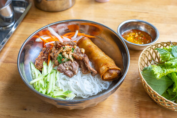 Famous Vietnam food with rice noodles, grill pork and vegetable