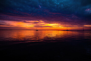 Early morning, sunrise over sea, sunset reflecting. Sunrise over the sea and beautiful cloudscape.