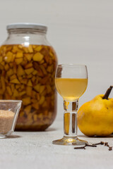 Homemade quince liqueur. Maceration of quinces in water, cane sugar, cinnamon, cloves and alcohol.