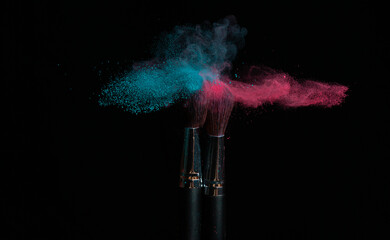 Blue and pink makeup powder brushes hit together in mixed cloud - 477575855