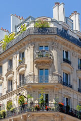 Corner of of typical house with balcony and flowers. The Marais district, Paris, France