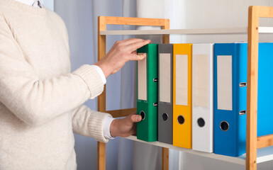 Young man working with documents in office
