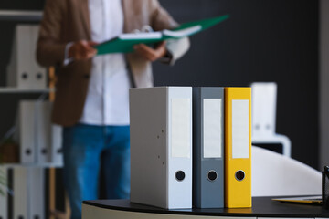 Folders on table in office, closeup