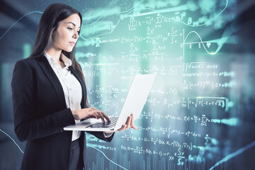 Attractive young european businesswoman using laptop with abstract mathematical formulas hologram in blurry office interior. Science and education concept. Double exposure.