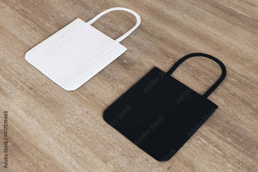 Poster top view and close up of blank black and white shoppers on wooden surface background. mock up, adver