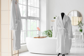 White bathrobes in modern bathroom