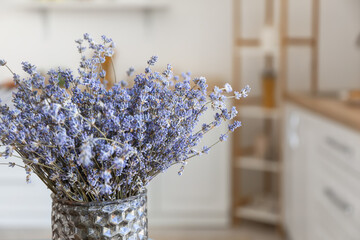 Vase with beautiful lavender flowers in kitchen, closeup