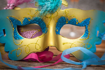golden carnival mask on wooden background