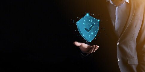 Businessman hold low poly polygon shield with a tick icon.Secure Access System Concept.Business Financial Warranty for Investment.antivirus concept.Technology security.Protection network,safe data. © Ivan