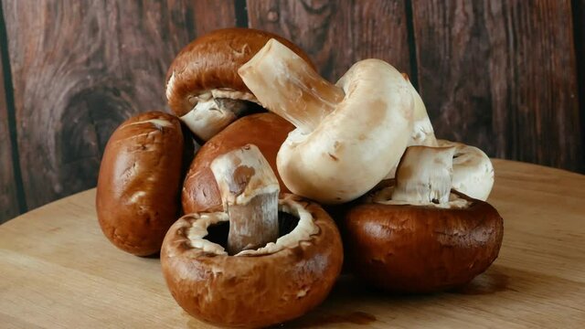 Fresh Brown and White Champignon Mushhrooms in backet on wooden background, Royal champignon mushrooms
