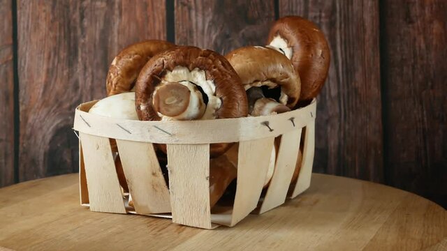Fresh Brown and White Champignon Mushhrooms in backet on wooden background, Royal champignon mushrooms