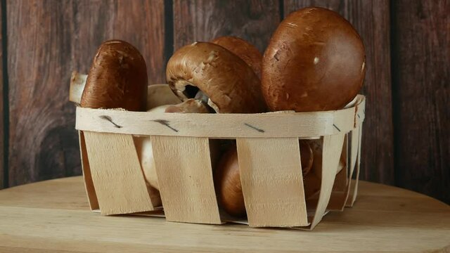 Fresh Brown and White Champignon Mushhrooms in backet on wooden background, Royal champignon mushrooms