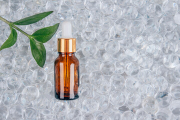 Mock up of dropper bottle with face anti aging serum with collagen and peptides on gel bubbles background with copy space. Cosmetic fluid collagen or essential oil. Skin care routine