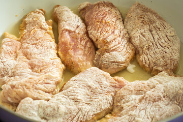 frying raw chicken breast fillet flour covered closeup